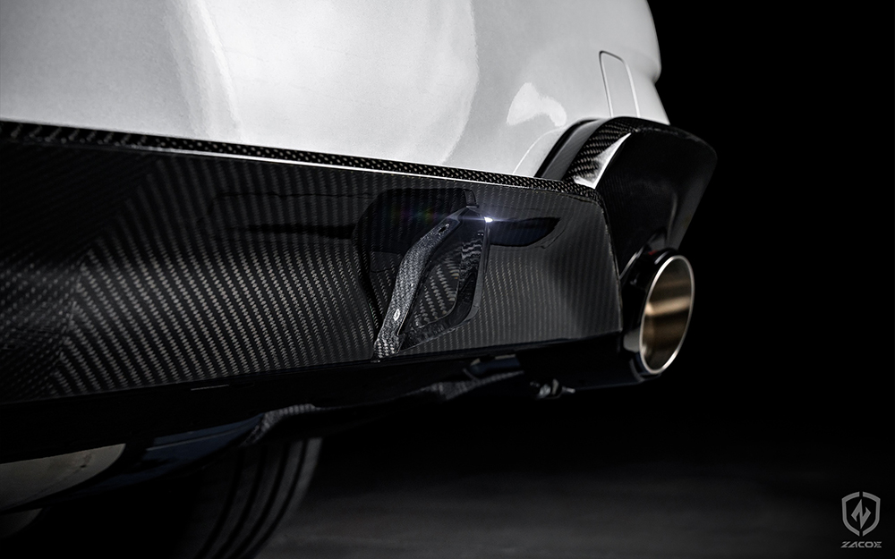 Carbon fiber diffuser installed on BMW G20 320i Sedan. Fi EXHAUST carbon fiber tips poking out.